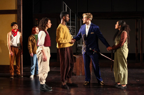 A group of actors on stage performing a scene
