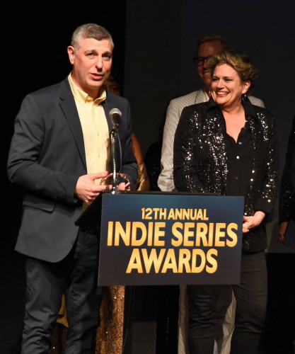 Jason Cicci accepts an Indie Series Award at a podium