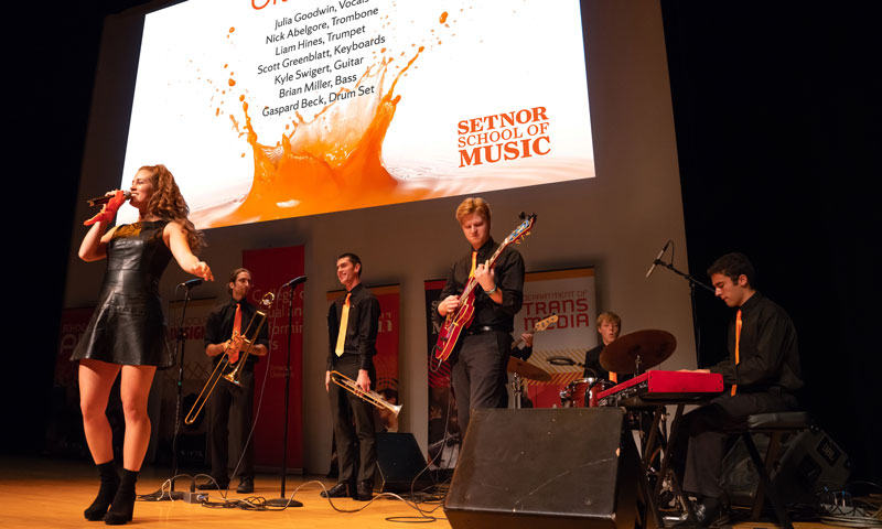 A jazz ensemble of students performs on stage