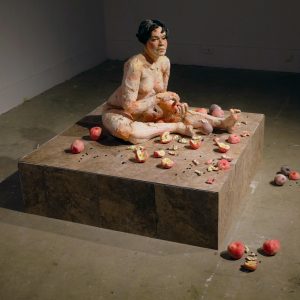 A woman surrounded by apples.